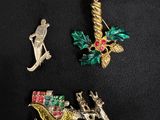 three christmas brooches on a black background