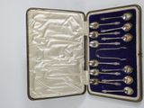 a case with silverware inside of it on a white surface