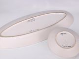 a white plate and a white bowl on a white surface