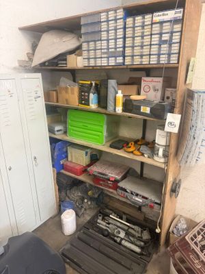 a room with a shelf full of tools and other items