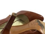 pair of women ' s brown leather shoes on a white surface