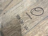 a close up of a wooden barrel with a logo on it