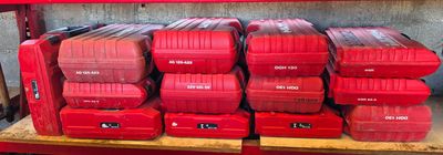 many red boxes stacked on a shelf in a garage
