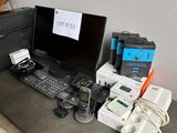 a desk with a computer, keyboard, mouse, and other electronics on it