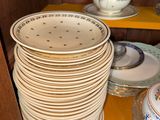 a lot of plates on a shelf in a cabinet