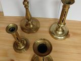 four candles that are sitting on a wooden table