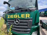 a green truck that is parked on the side of the road