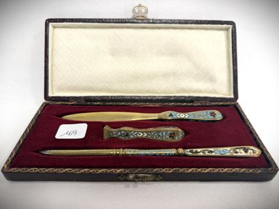 a box with a pen, knife, and other items in it