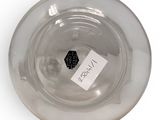 a glass bowl with a label on it on a white surface