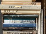 many books stacked on top of each other in a box