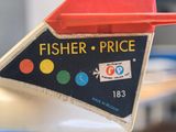 a sign that says fisher price on the side of a parking meter