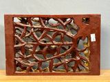 a decorative wooden panel with birds on it on a table