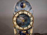 a clock that is sitting on a table next to a pile of coins