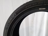 a close up of a tire on a table with a white background