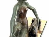 statue of a woman sitting on a bench with a dog