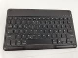 a close up of a black keyboard on a white surface