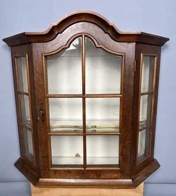an old wooden display case with glass doors