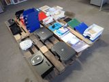 a pile of electronics on a pallet in a warehouse