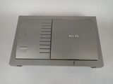 a silver electronic device on a white surface