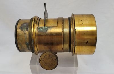 a small brass object on a stand with a hook