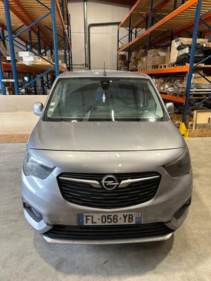 the front end of a silver opel parked in a warehouse
