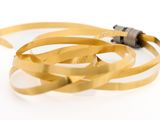 a close up of a gold colored cable on a white surface