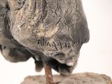 a statue of an elephant that is standing on a rock