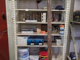 a room with several shelves and buckets of paint