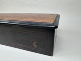 an old wooden box sitting on top of a white surface