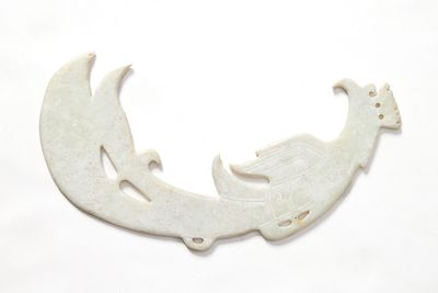 a picture of a white bird brooch on a white background