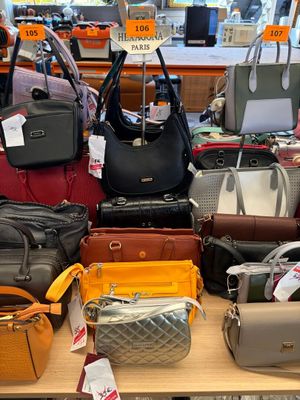 a lot of purses on a table in a store