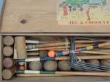 a wooden box with a bunch of croquets in it