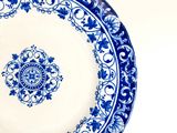 a blue and white plate with a design on it