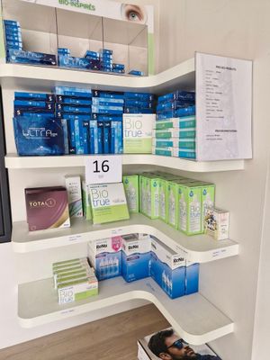 a corner shelf in the corner of a room with a lot of boxes on it