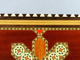 a wooden box with a decorative design on it