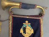 a gold horn and a blue and red banner hanging on a wall