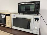 two microwaves sitting on top of each other on a counter