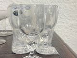 three wine glasses sitting on a table next to each other