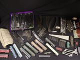 many different types of toy trains on a black table