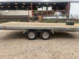 a flatbed trailer parked in front of a building