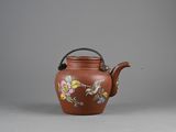 chinese brown teapot decorated with birds and flowers on a gray background