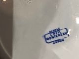 a close up of a white bowl with a blue label on it
