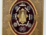 an image of a gold and red plaque with a picture of a buddha
