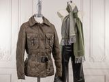 pair of women ' s jackets and pants on mannequins in a white room