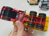 a person holding a toy car in their hand