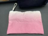 a close up of a pink and white bag on a table