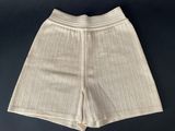 a close up of a pair of white shorts on a black surface