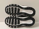 the soles of a pair of black and white shoes on a white surface