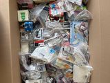 a cardboard box full of electronic devices and other items