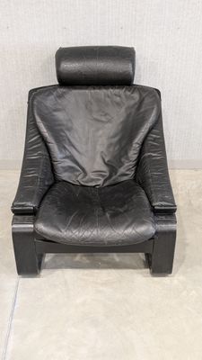 black leather reclining chair in a corner of a room